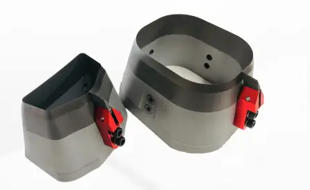 Industrial metal cutting accessories with red adjustment knobs isolated on a white background