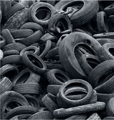 Pile of used rubber tires stacked together for recycling or industrial reuse